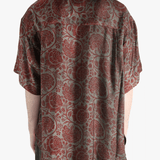 Grey shirt worn by a person, showing the shirt's fit