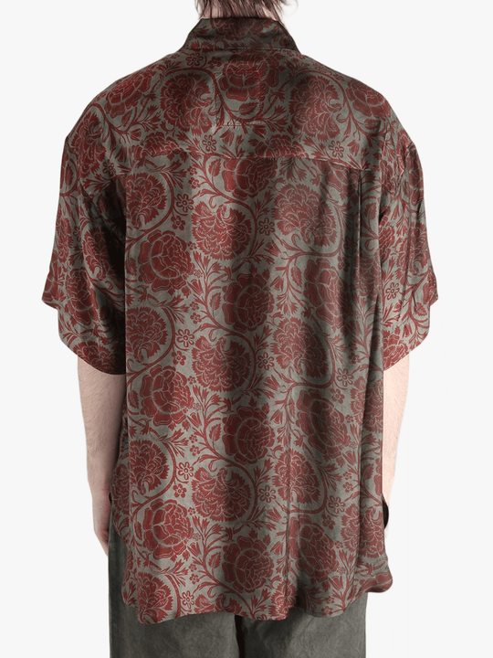 Grey shirt worn by a person, showing the shirt's fit