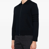 Blue knitwear worn by a person, showing the knitwear's fit