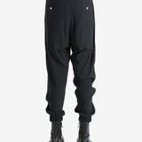 Black pant worn by a person, showing the pant's fit