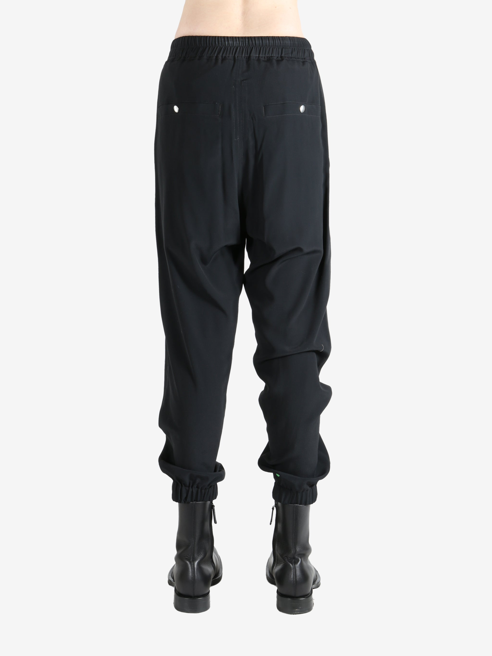 Black pant worn by a person, showing the pant's fit