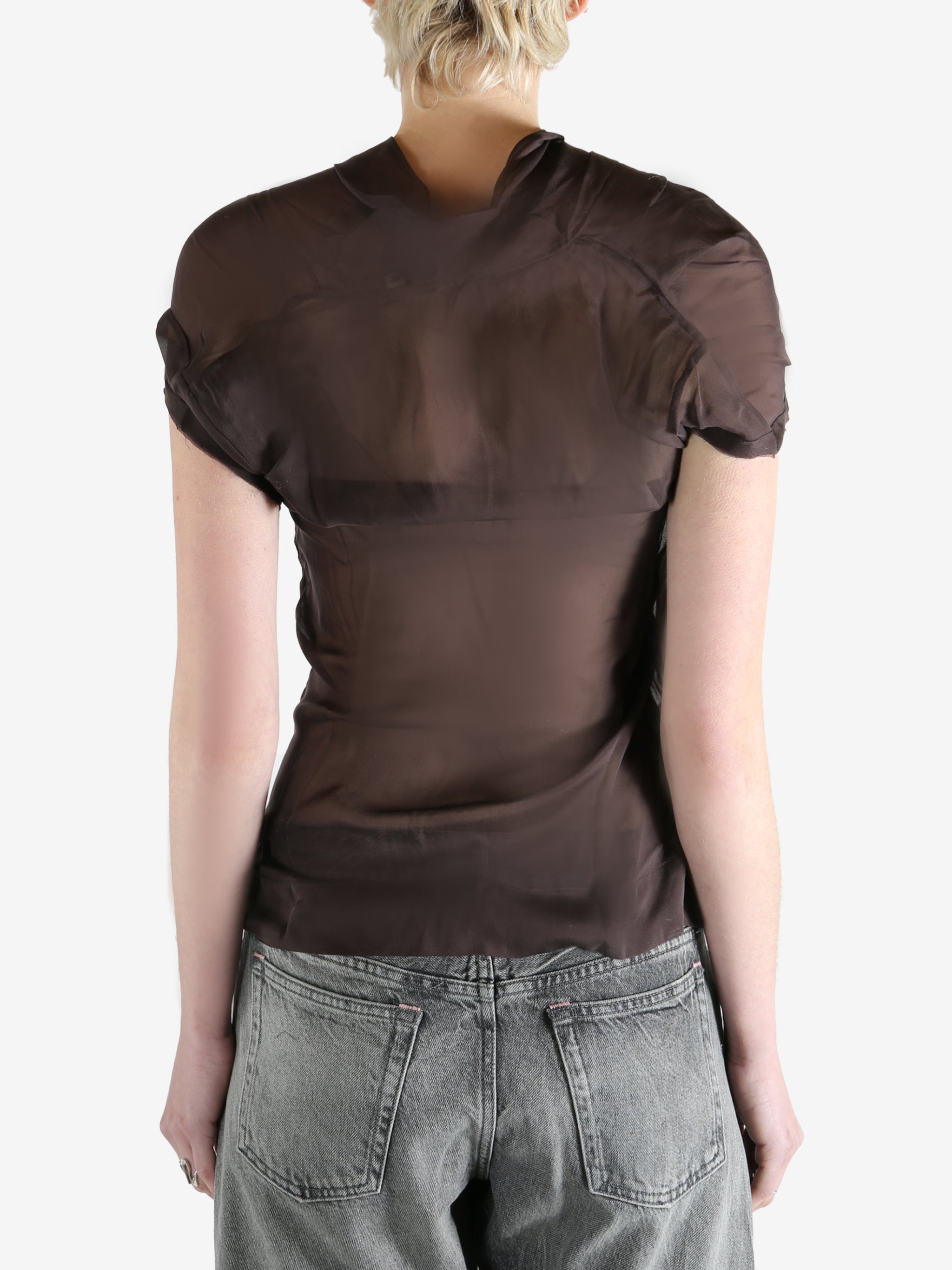 brown top worn by a person, showing the top fit