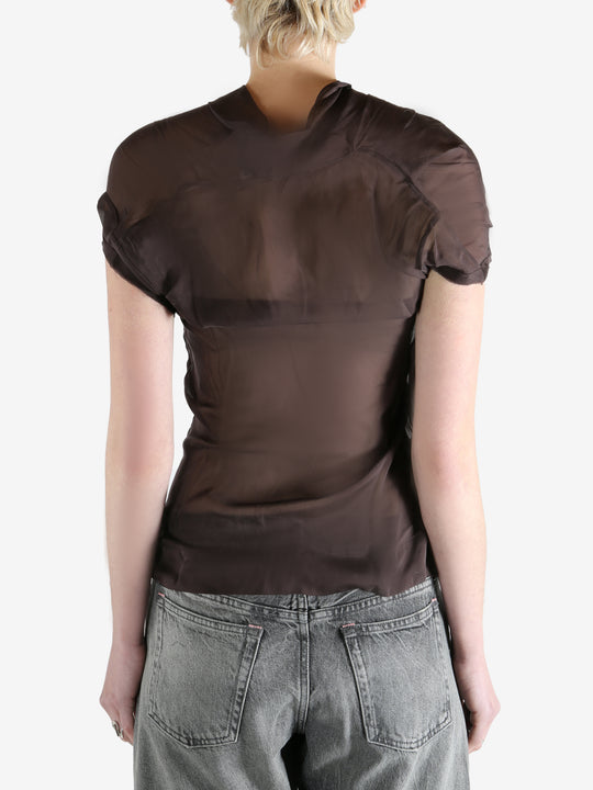 brown top worn by a person, showing the top fit