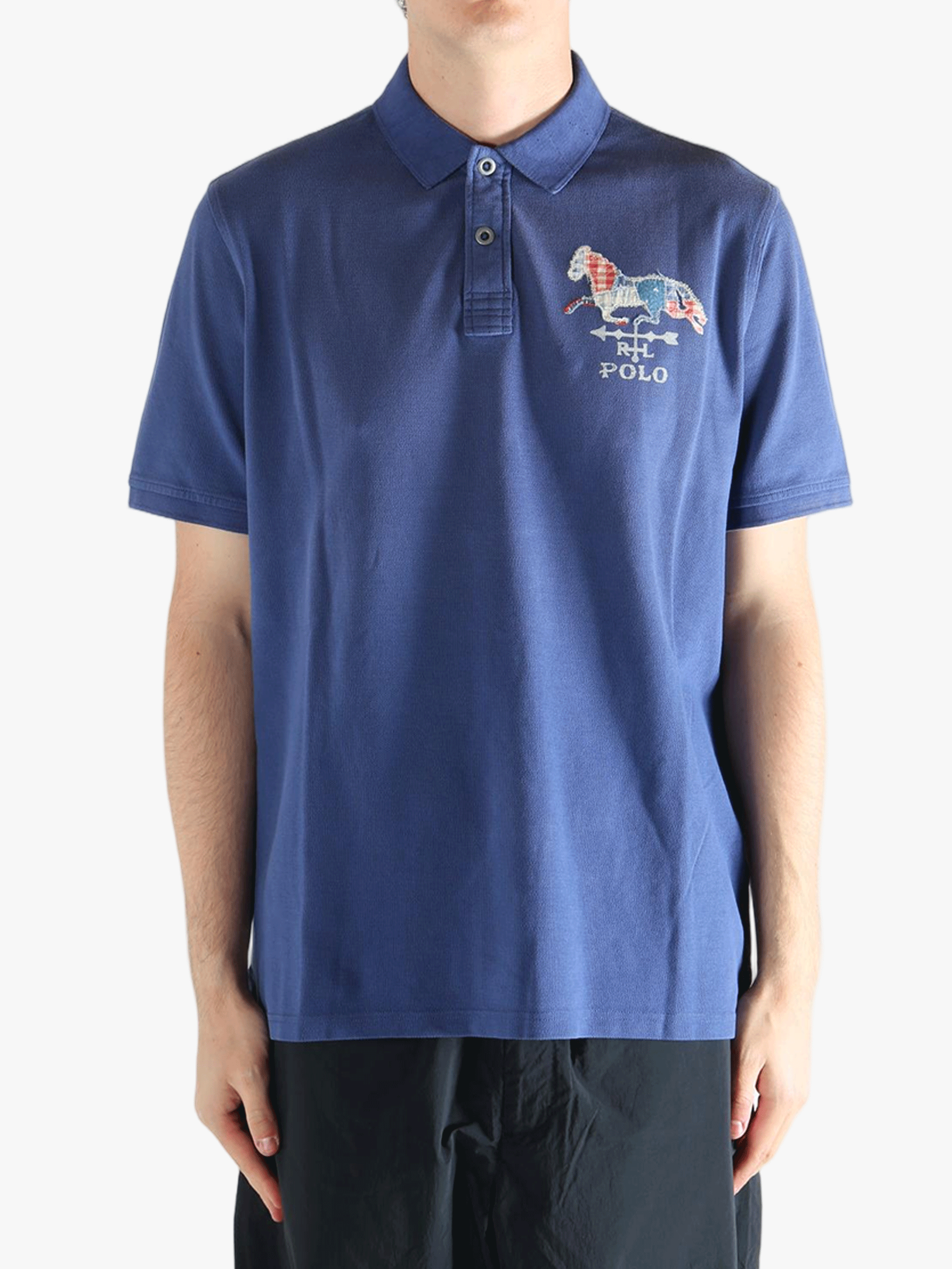Blue polo shirt worn by a person, showing the shirt's fit