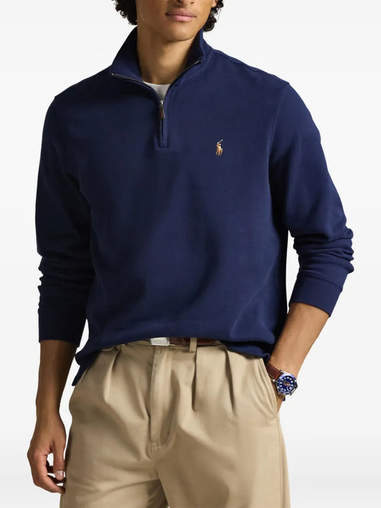 Navy knitwear worn by a person, showing the knitwear fit