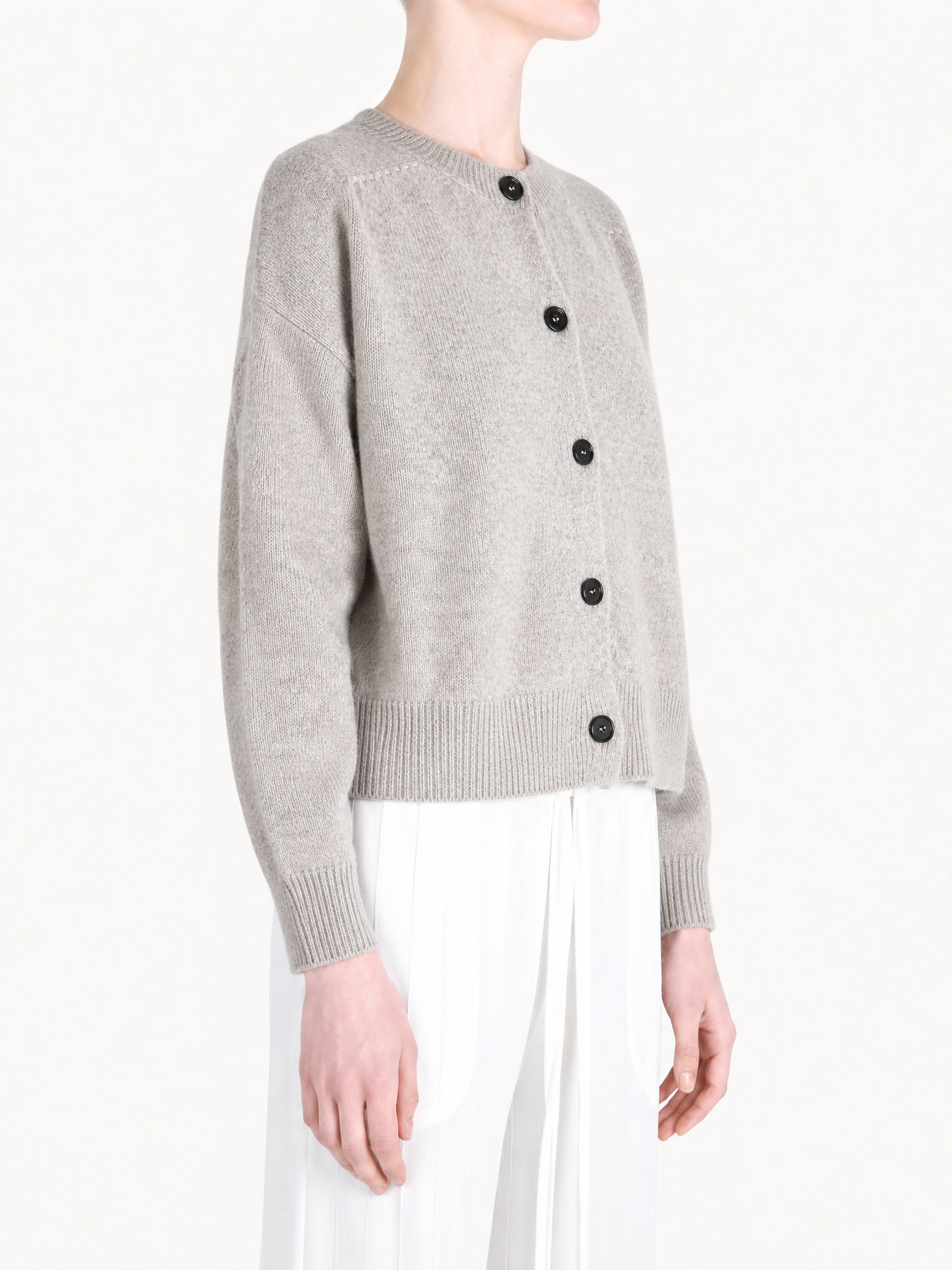 Grey knitwear worn by a person, showing the knitwear fit