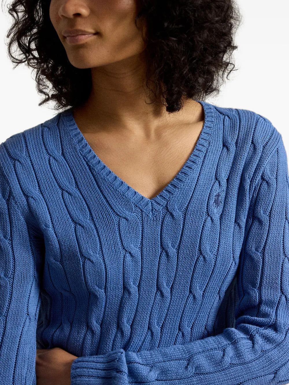Blue knitwear worn by a person, showing the knitwear fit