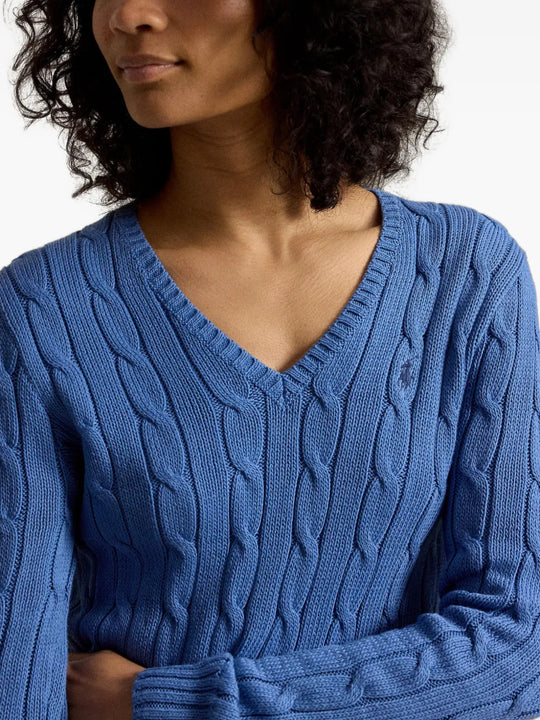 Blue knitwear worn by a person, showing the knitwear fit