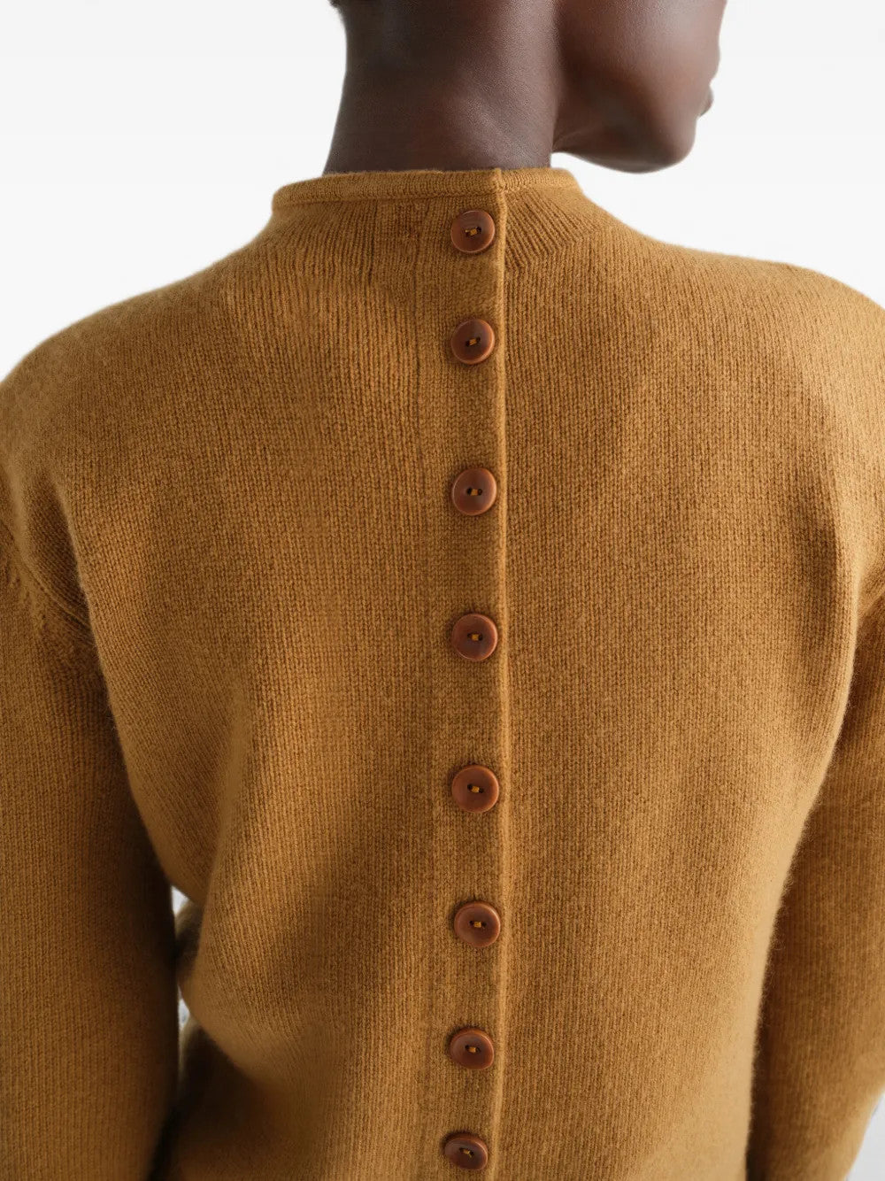 Tan hoodie worn by a person, showing the hoodie fit