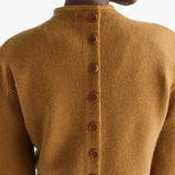 Tan hoodie worn by a person, showing the hoodie fit