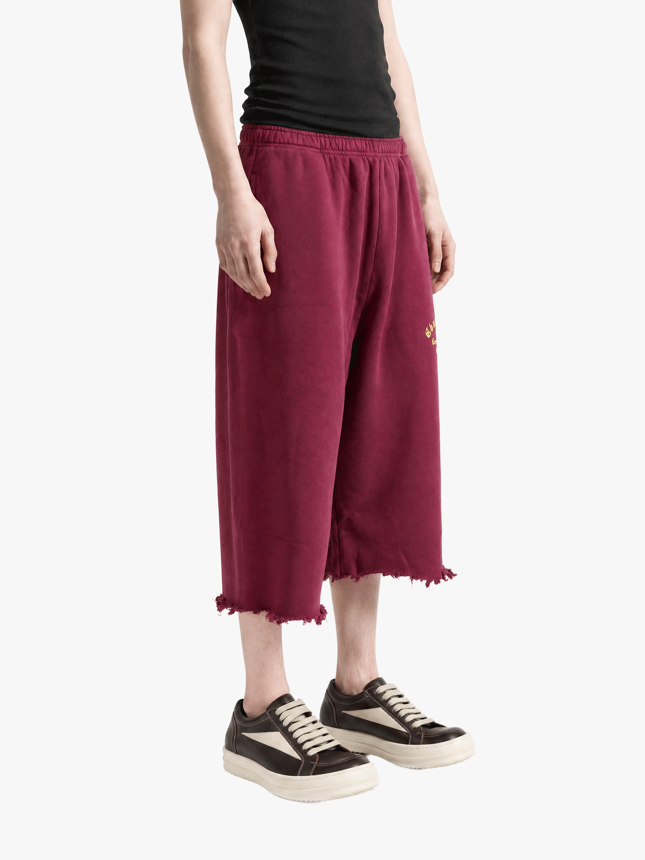 Burgundy pants worn by a person, showing the pants fit