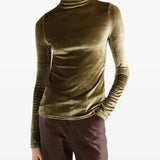 Green top worn by a person, showing the top fit