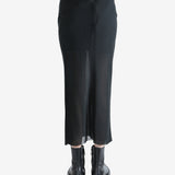 Black skirt worn by a person, shwing the skirt's fit