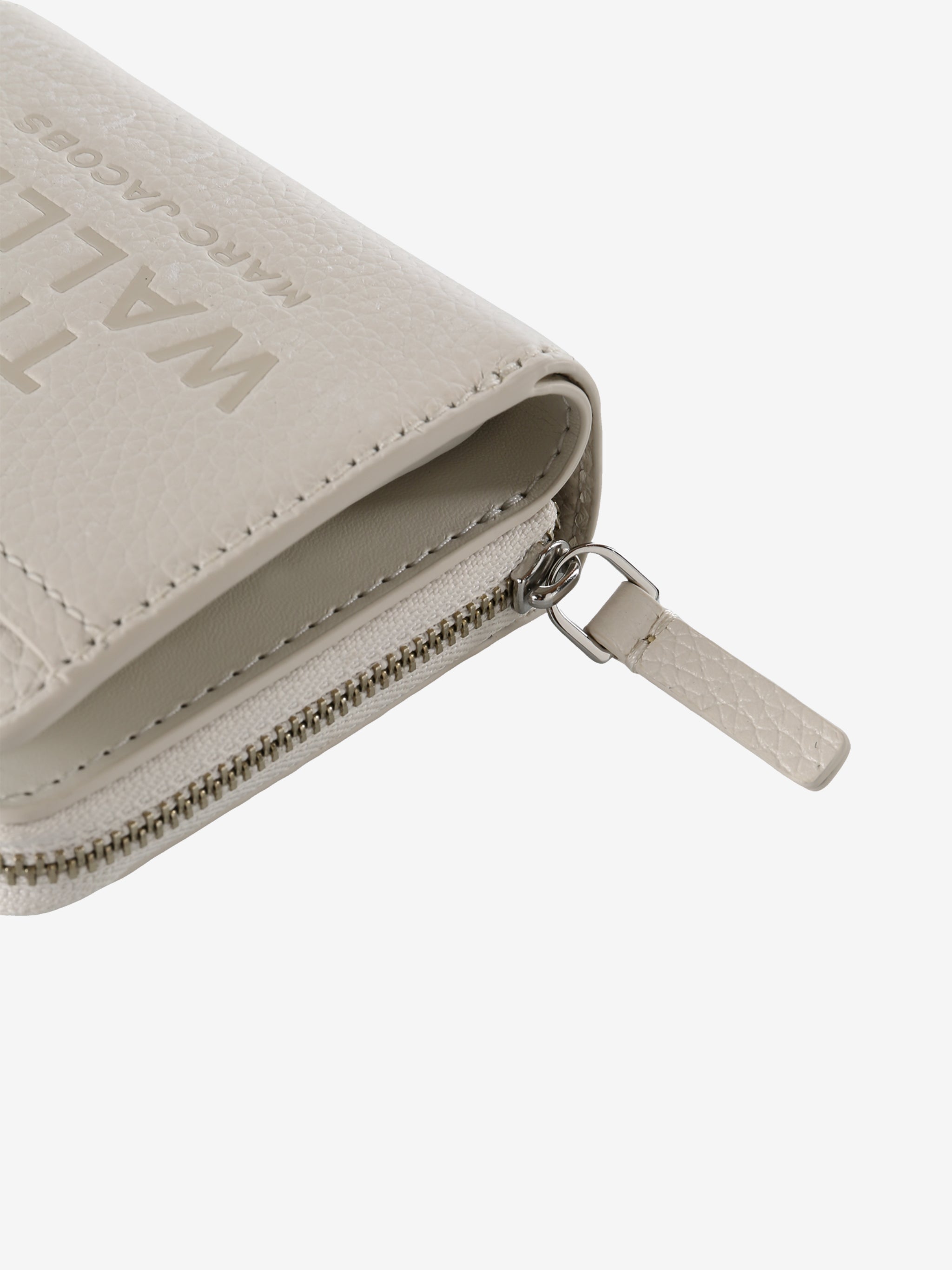 Close up of tan bag, showing texture of the leather fabric