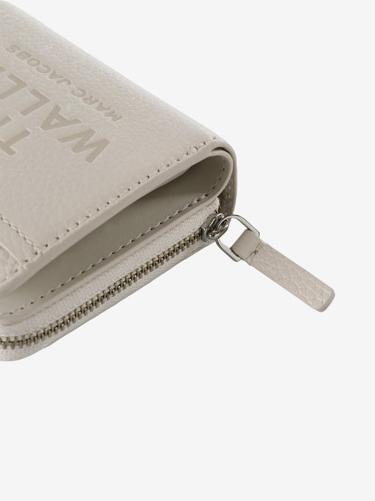 Close up of tan bag, showing texture of the leather fabric