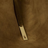 Close up of green bag, showing texture of the calf leather fabric