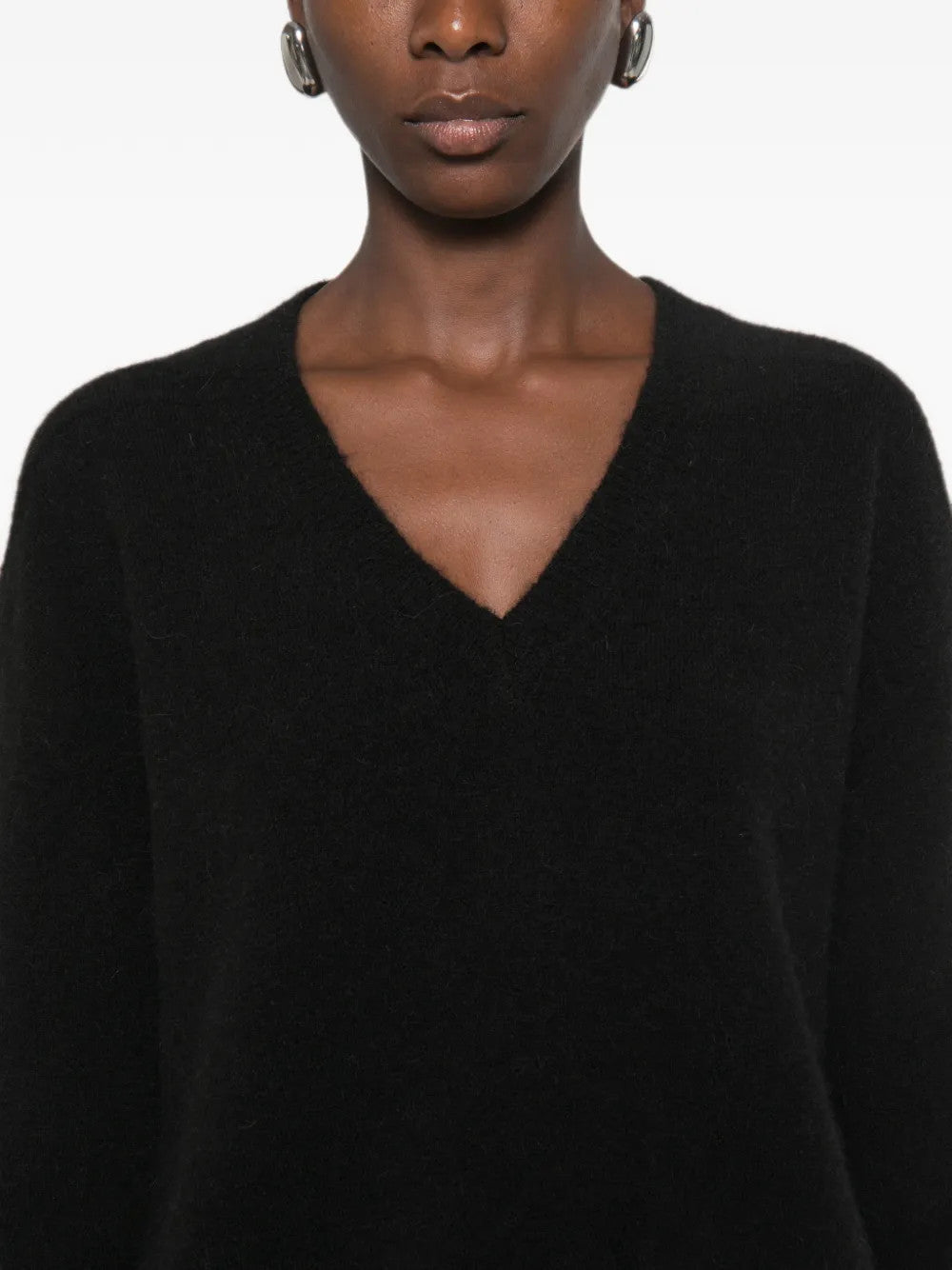 Black top worn by a person, showing the top fit