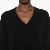 Black top worn by a person, showing the top fit