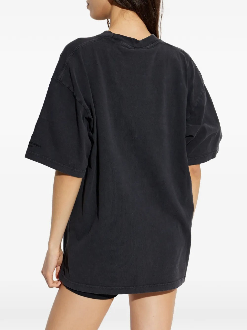 Black T-shirts worn by a person, showing the T-shirt's fit