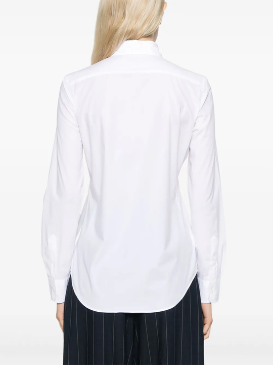 White shirt worn by a person, showing the shirt's fit