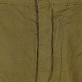 Close up of green pants, showing texture of the cotton fabric