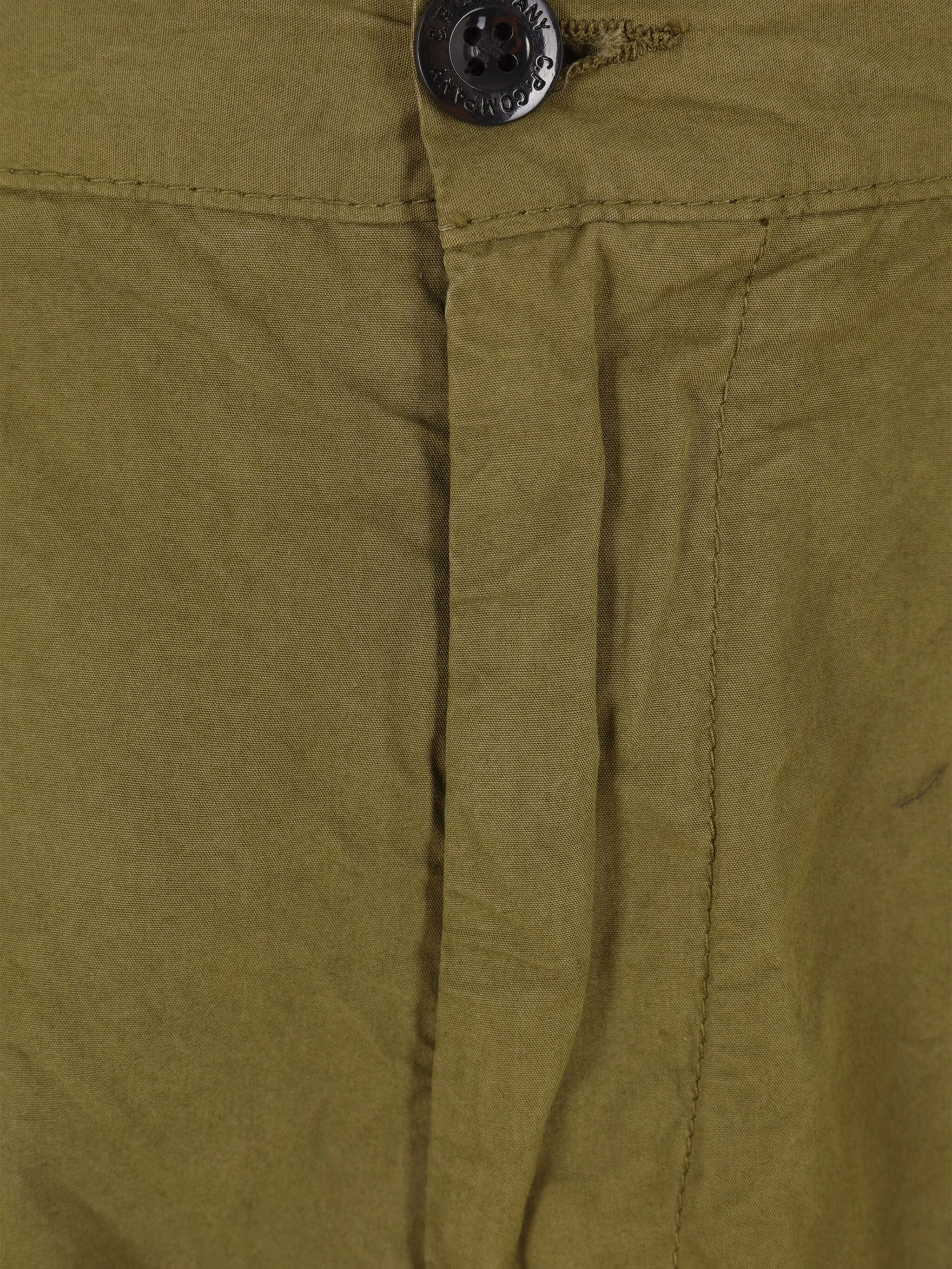Close up of green pants, showing texture of the cotton fabric