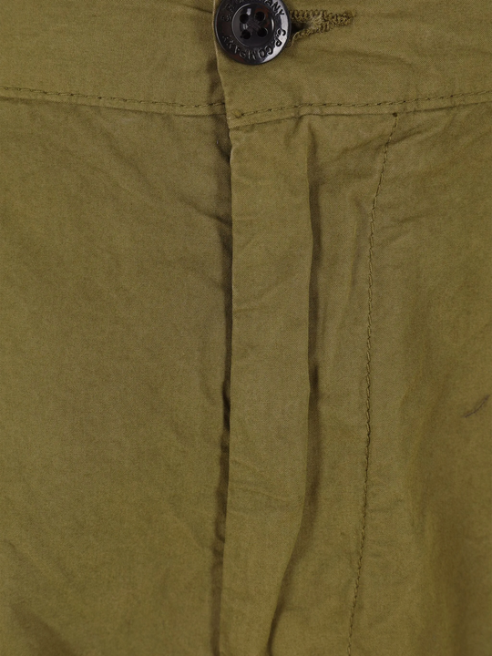 Close up of green pants, showing texture of the cotton fabric
