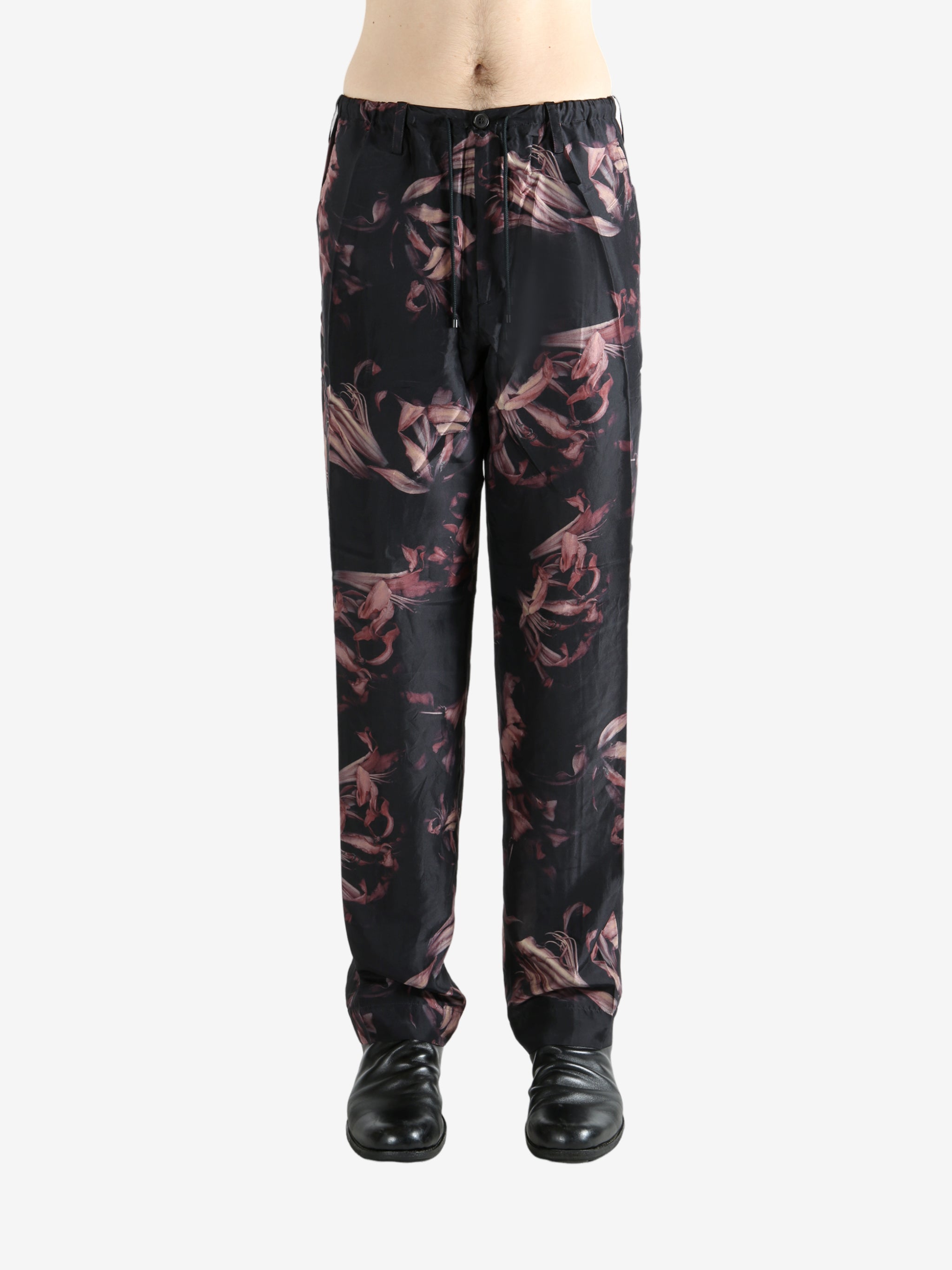 Black pants worn by a person, showing the pants' fit