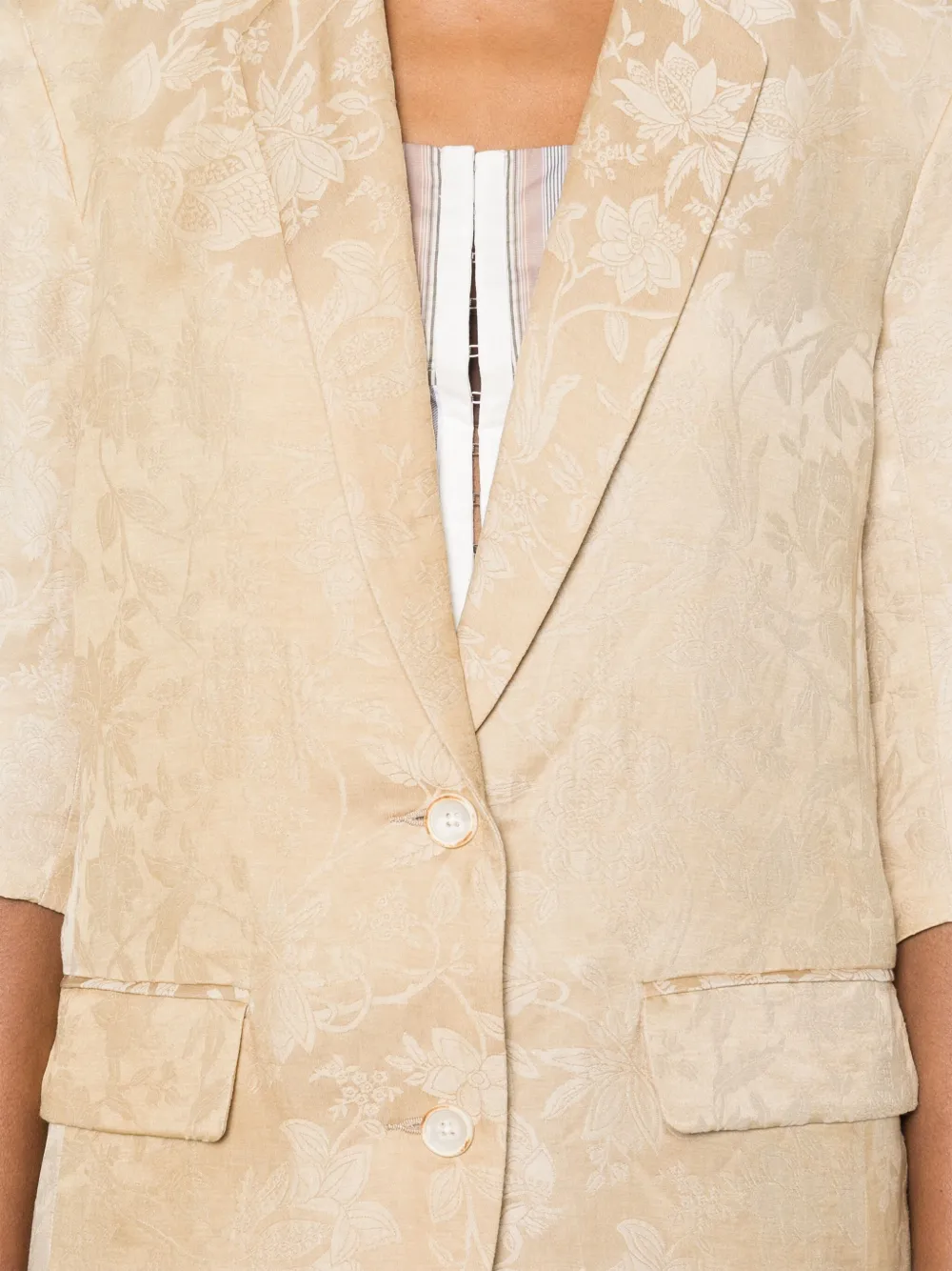 Close up of tan jacket,showing texture of the linen flax fabric.