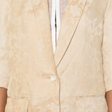 Close up of tan jacket,showing texture of the linen flax fabric.