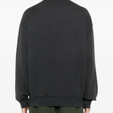 Black sweat worn by a person, showing the sweat's fit