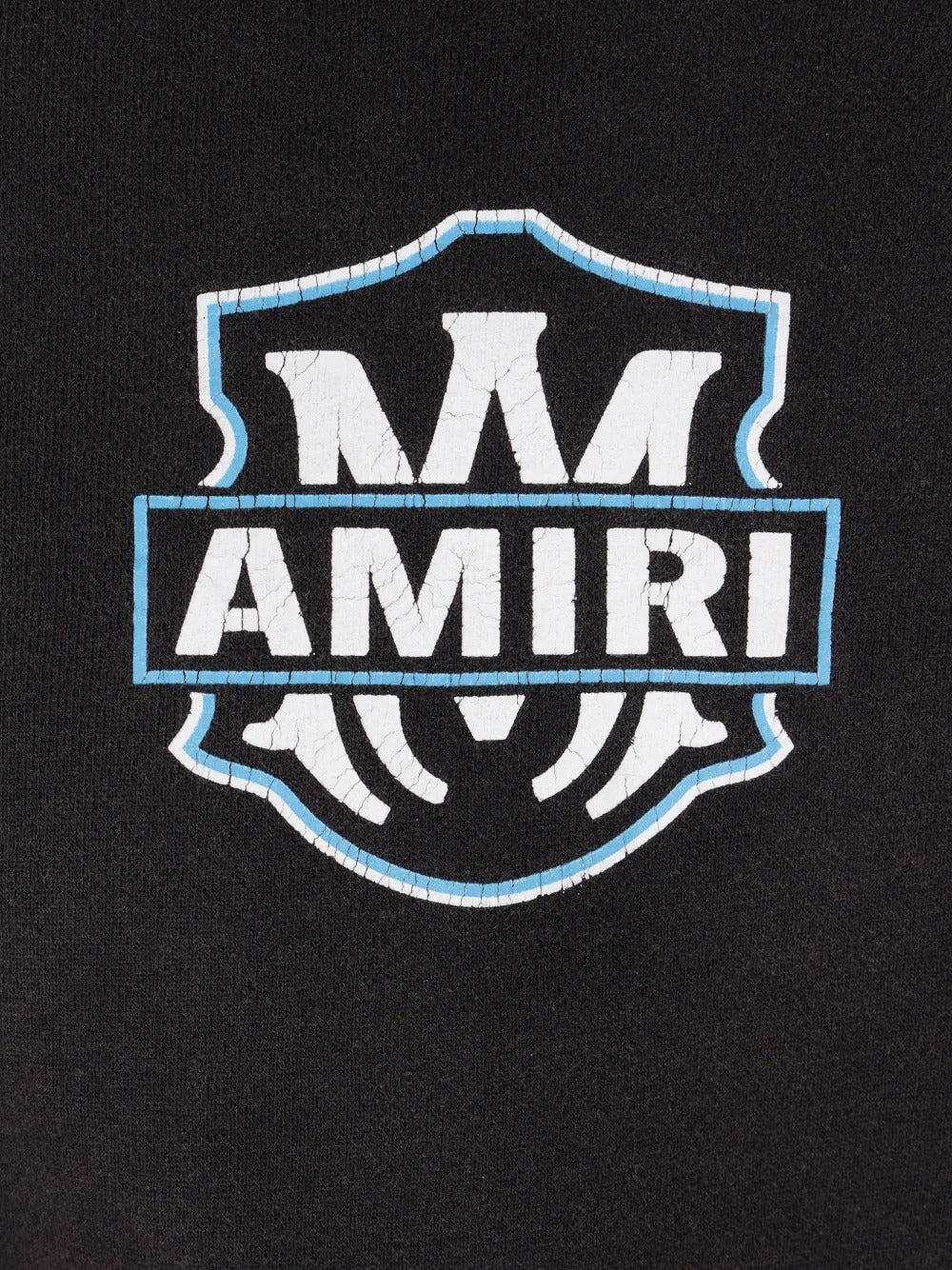 Close up of the black hoodie, showing texture of the cotton fabric