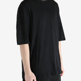 Black T-shirt worn by a person, showing the T-shirt fit