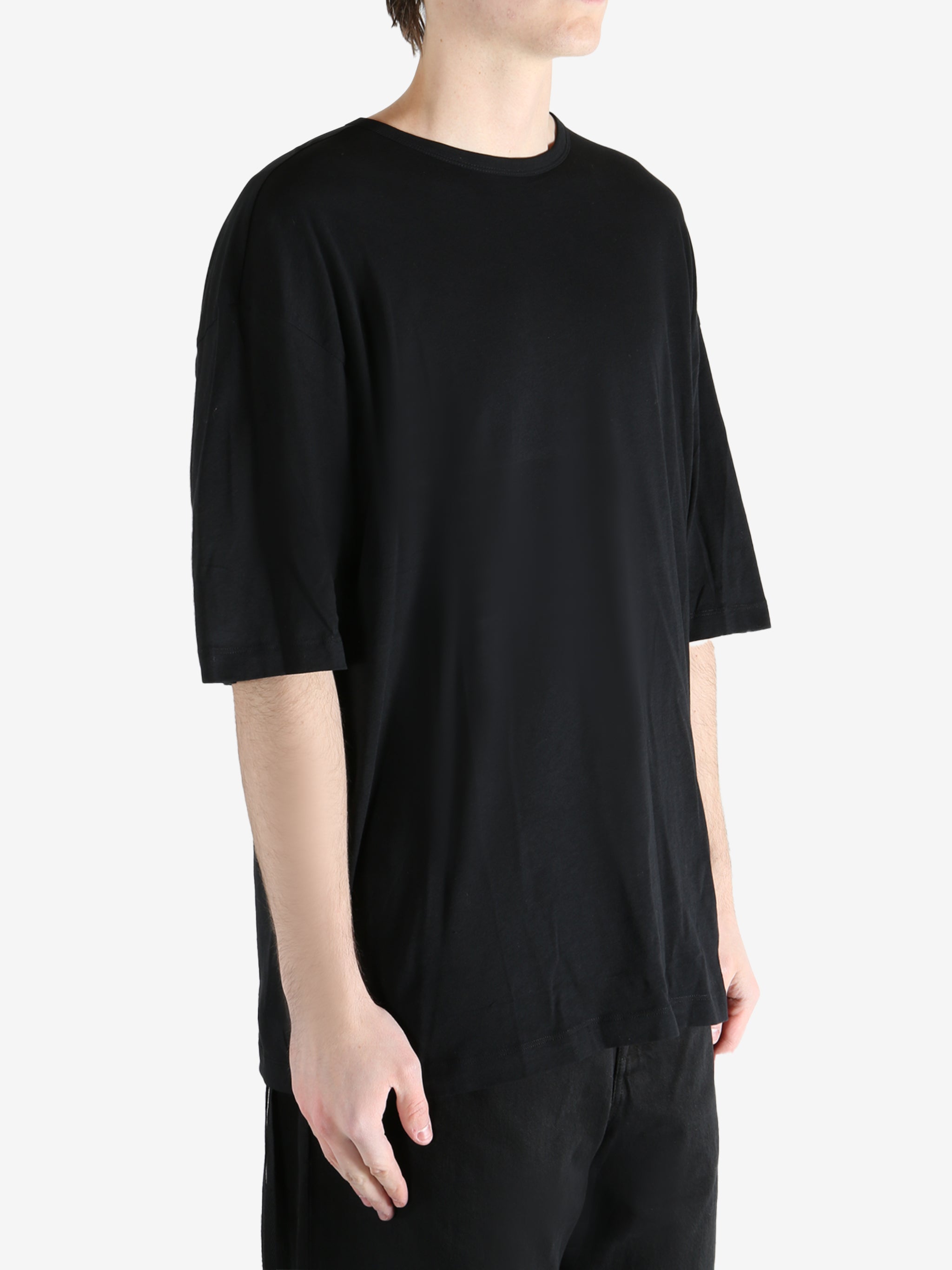 Black T-shirt worn by a person, showing the T-shirt fit