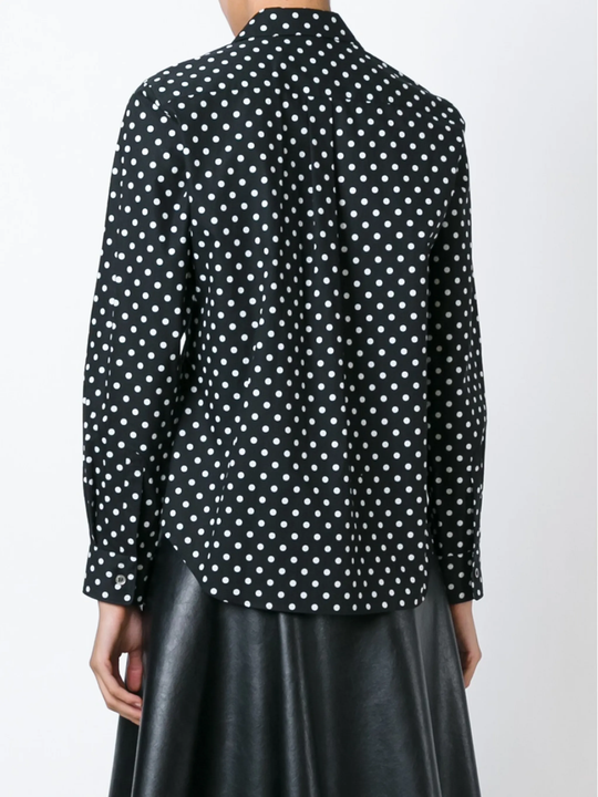 Black shirt  worn by a person, showing the shirt's fit