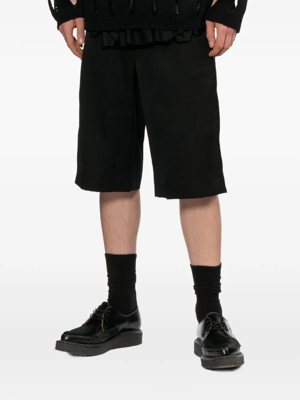 Black shorts worn by a person, showing the shorts's fit