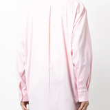 Pink shirt worn by a person, showing the shirt fit