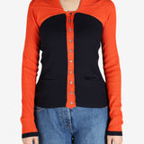 Orange top worn by a person, showing the top’s fit