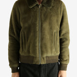 Green jacket worn by a person, showing the jacket's fit