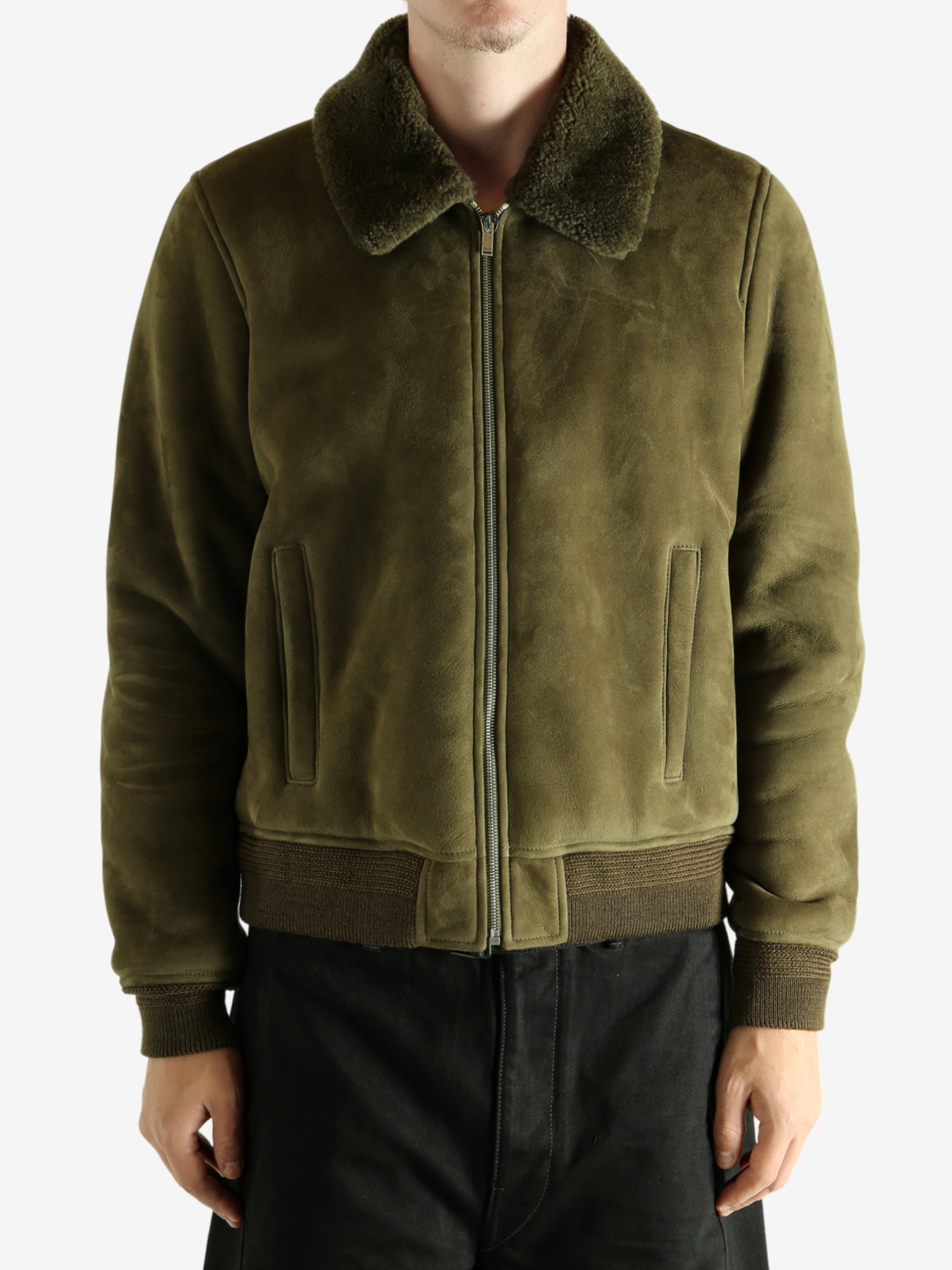Green jacket worn by a person, showing the jacket's fit
