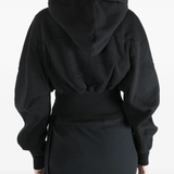 Black hoodie worn by a person, showing the  hoodie fit