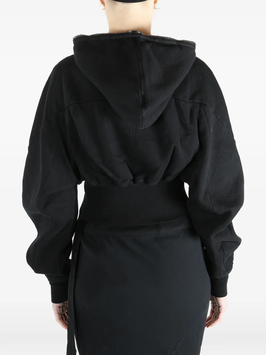 Black hoodie worn by a person, showing the  hoodie fit