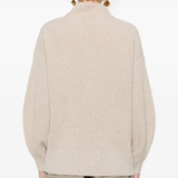 Tan knitwears worn by a person, showing the knitwears fit