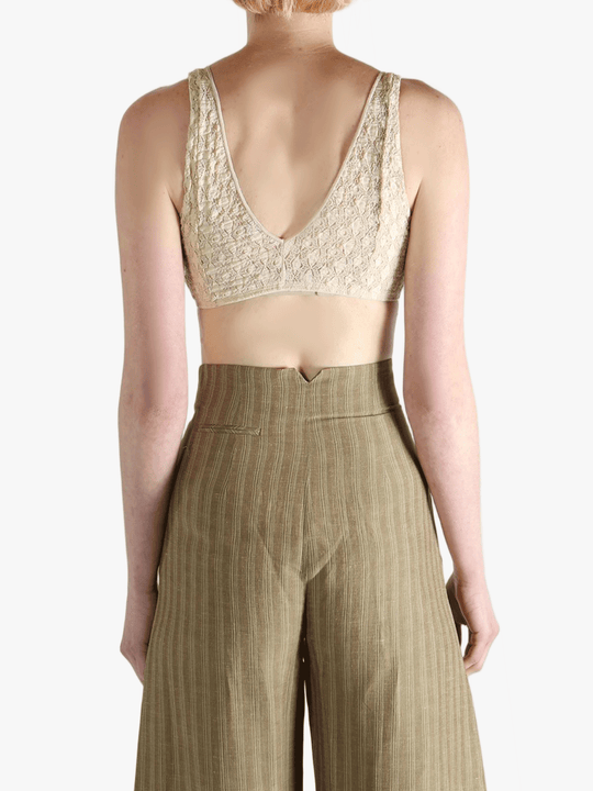 Tan bra worn by a person, showing the bra's fit