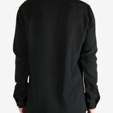 Black shirt worn by a person, showing the shirt's fit