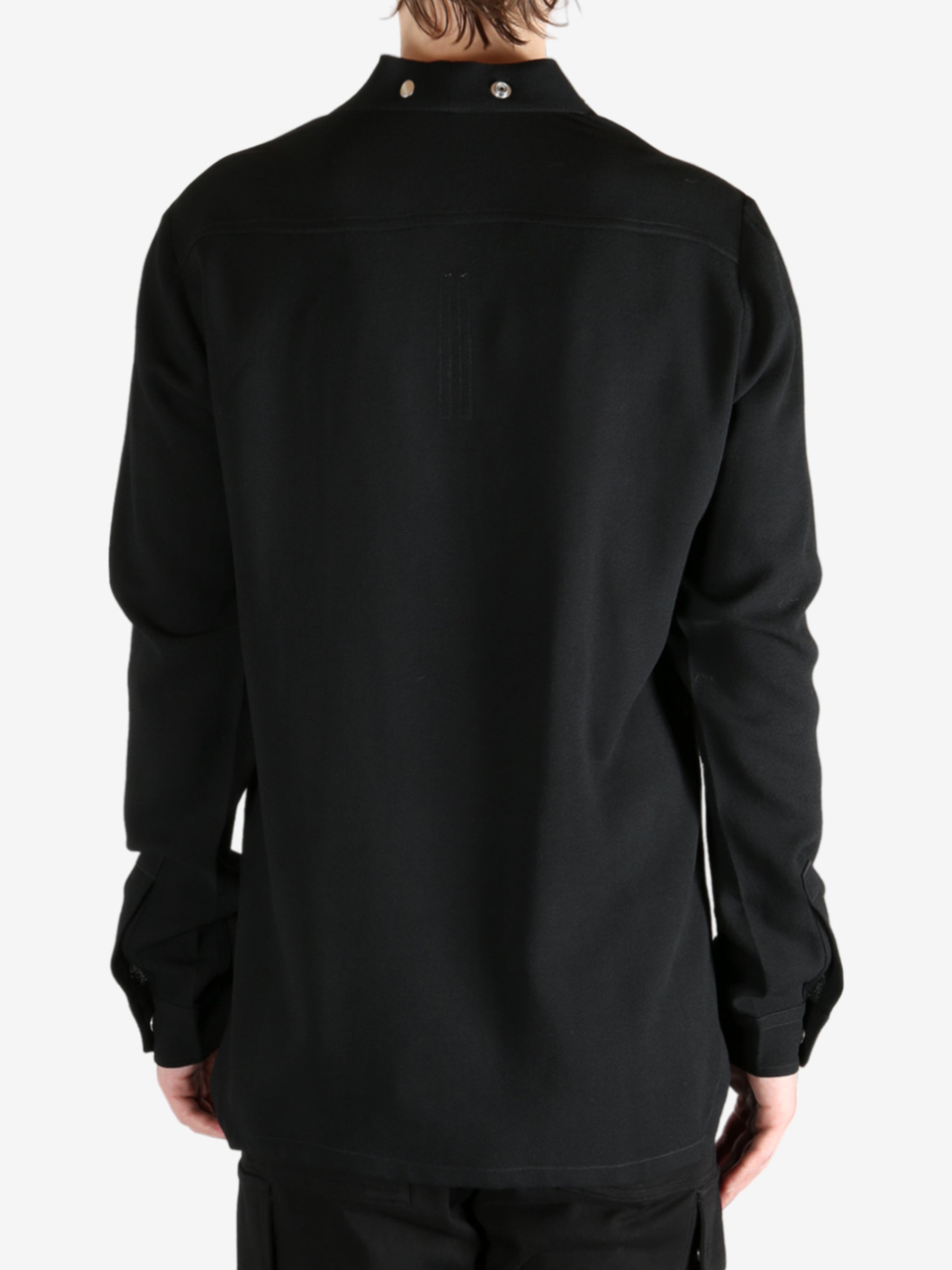 Black shirt worn by a person, showing the shirt's fit