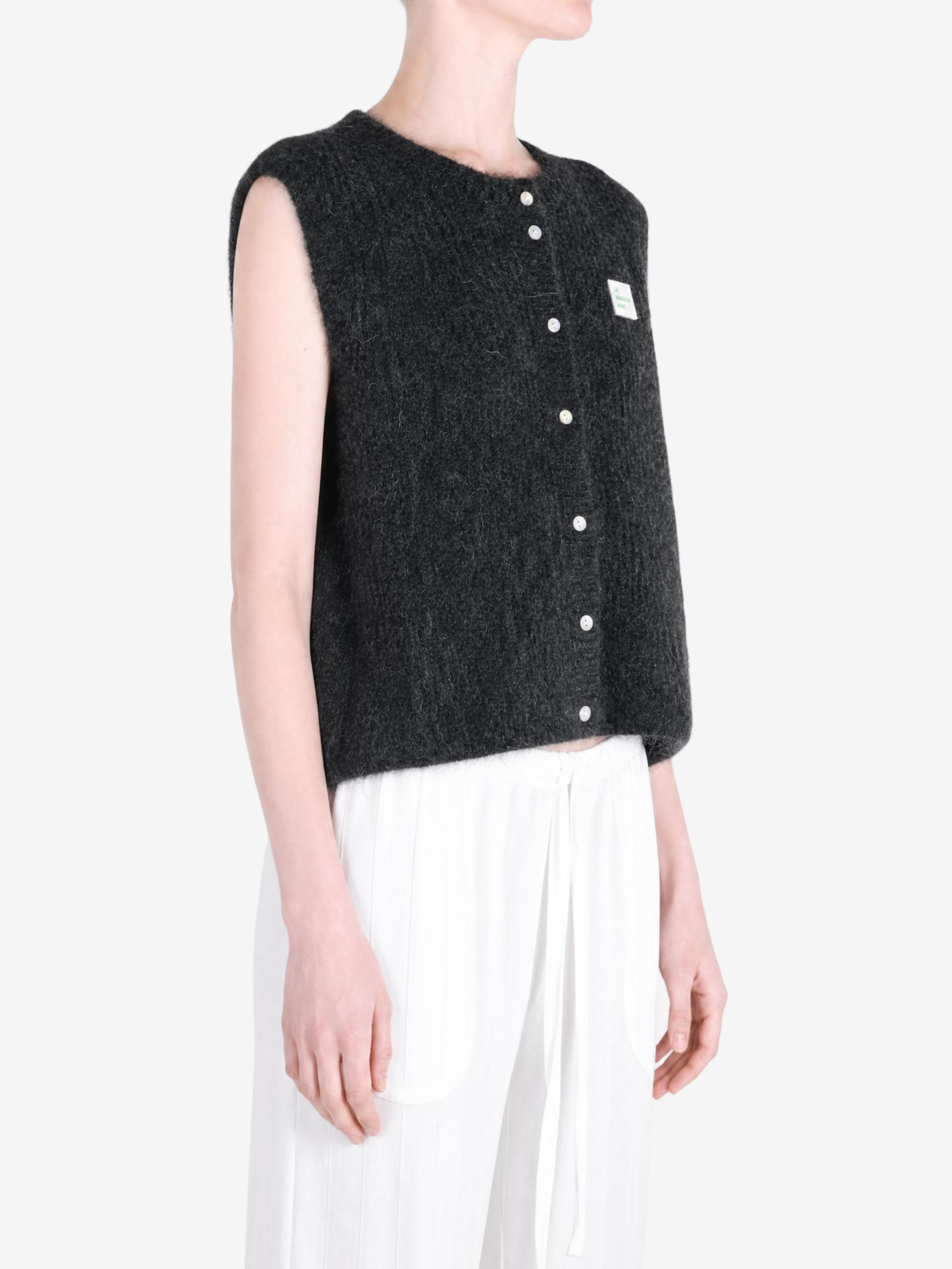 Black knitwear worn by a person, showing the knitwear fit