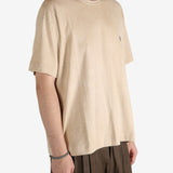 Tan t-shirt worn by a person, showing the t-shirt's fit
