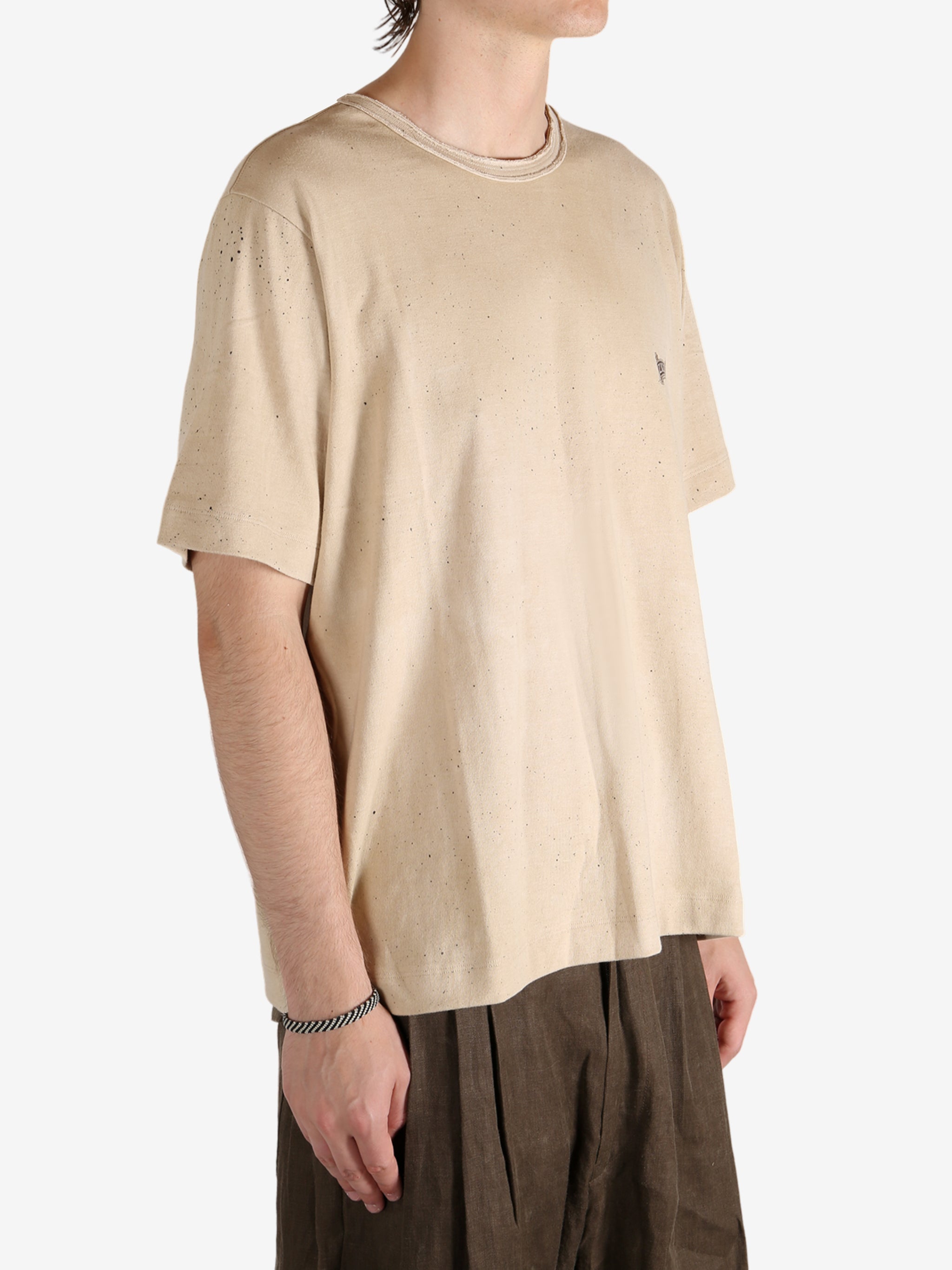 Tan t-shirt worn by a person, showing the t-shirt's fit