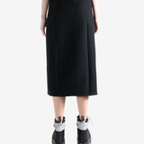 Black skirts worn by a person, showing the skirts fit